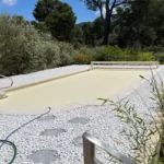 Volet de piscine hors sol sur mesure couleur vanille, fermé sur la piscine, photographié en pleine journée à Avignon.
